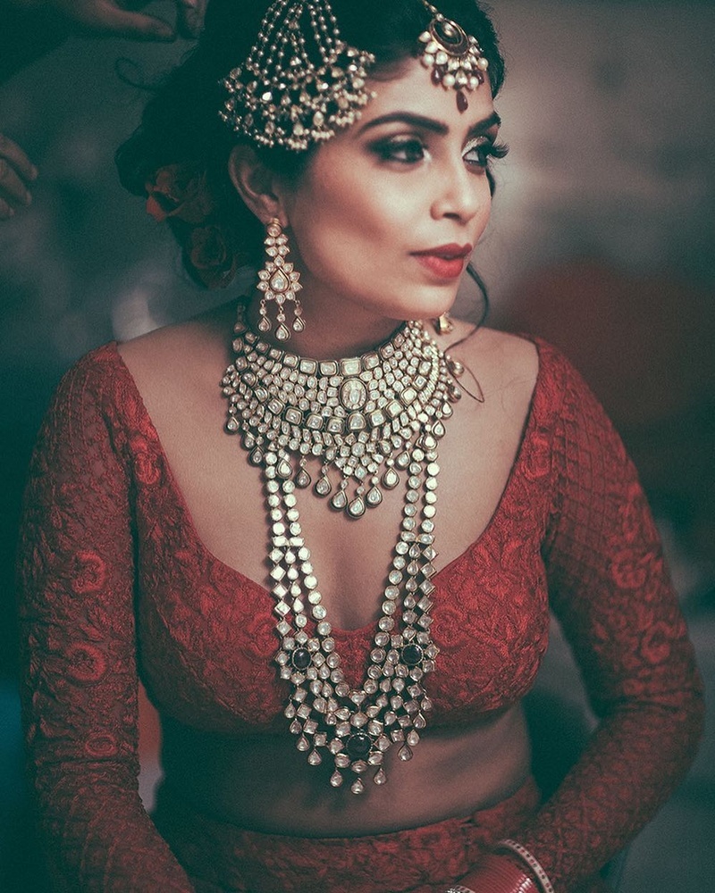 Photo of Bridal shot wearing jewellery in red lehenga