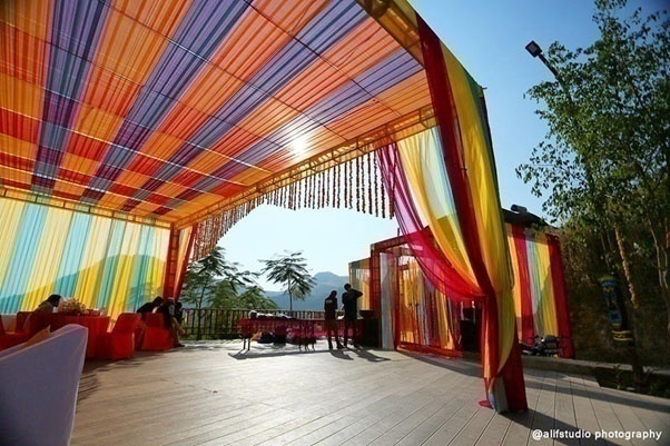 Outdoor wedding venue with colourful drapes