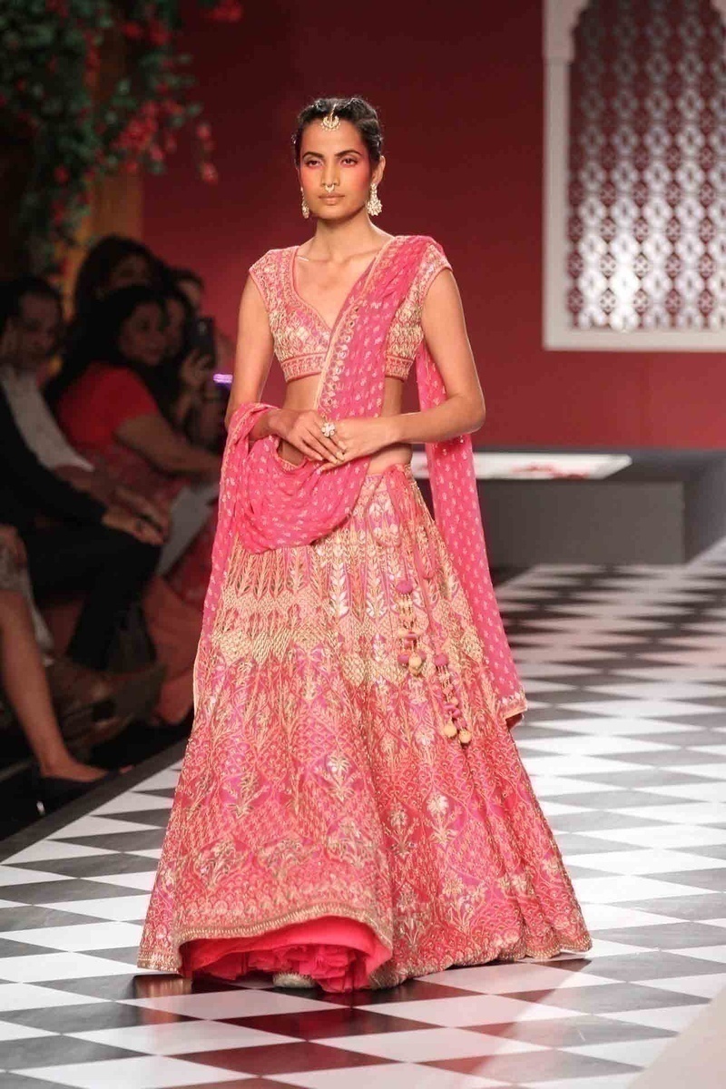 Anita Dongre does pink right! Pairing the classic bridal saree and lehenga with jackets and capes - Geometrical figures and nature inspired patterns dominated the pink section!