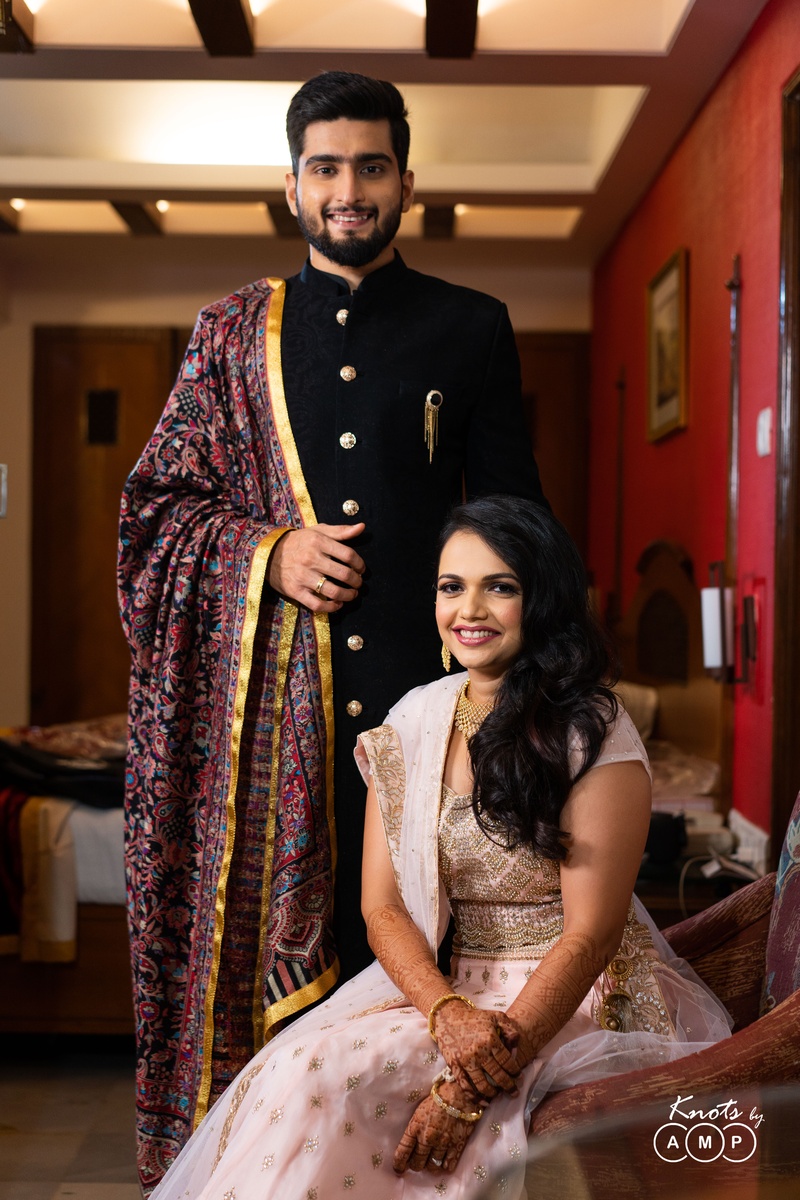 baby pink lehenga black achkan bride and groom reception the groom looks debonair in a black achkan while the bride flaunts a baby pink and gold lehenga 5