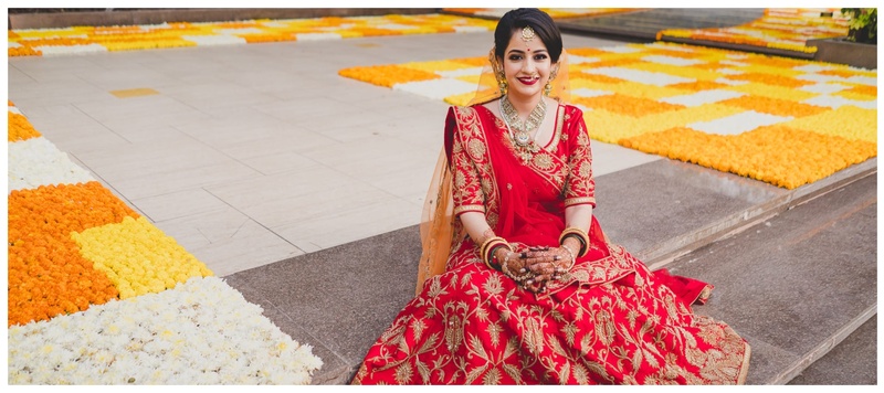 Siddharth & Aastha Ahmedabad : A classic Gujarati wedding with the bride wearing a beautiful red lehenga designed by herself.