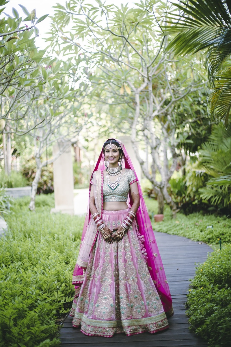 12. A pink and golden lehenga paired with emerald jewellery never fails!